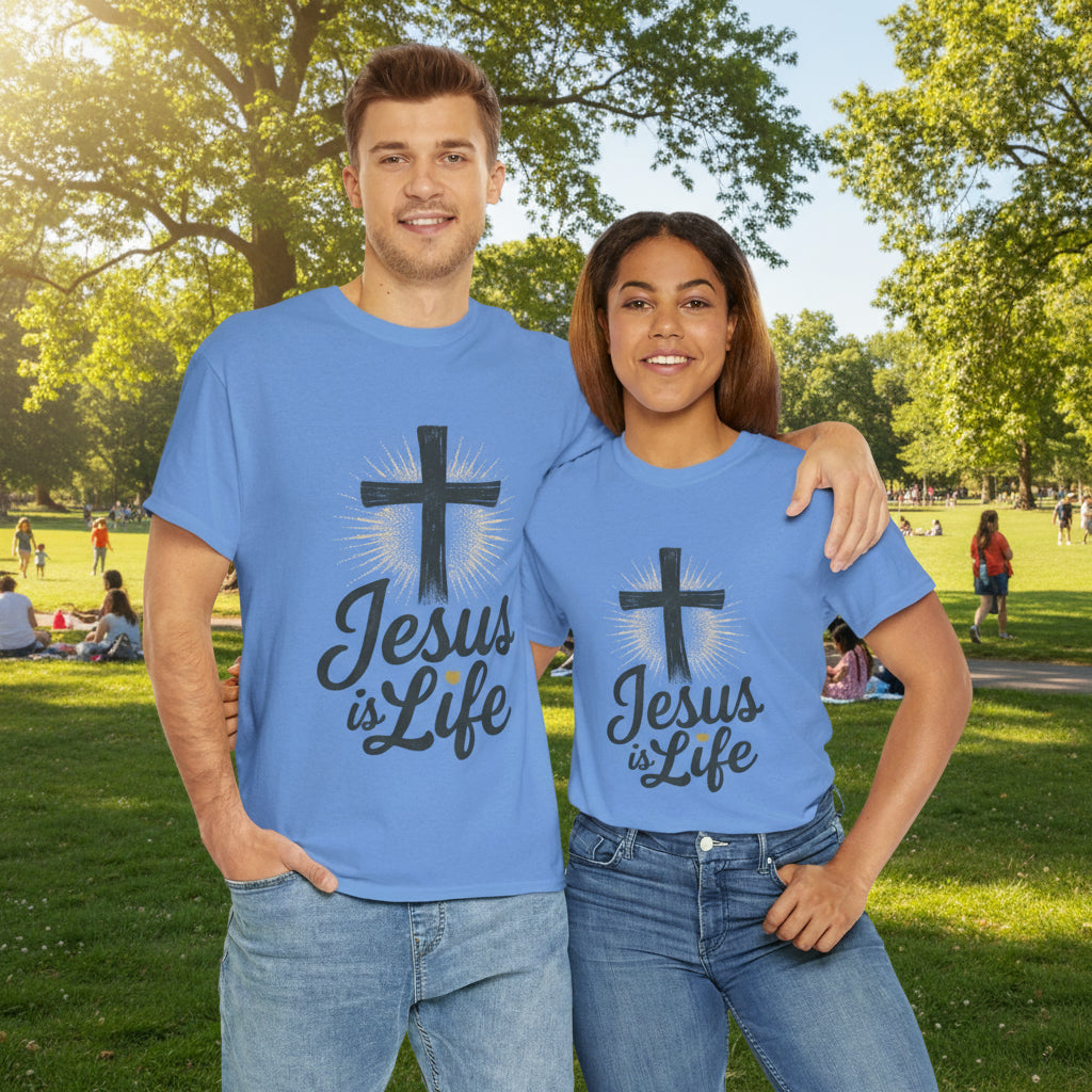 Two people wearing blue t-shirts with 'Jesus is Life' design in a park.

